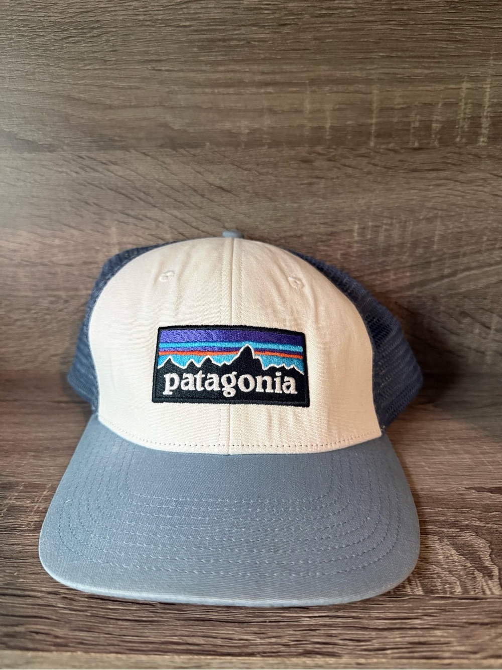 Patagonia men’s Cream Front & Light Blue Mesh Trucker Hat with Stripe Logo
